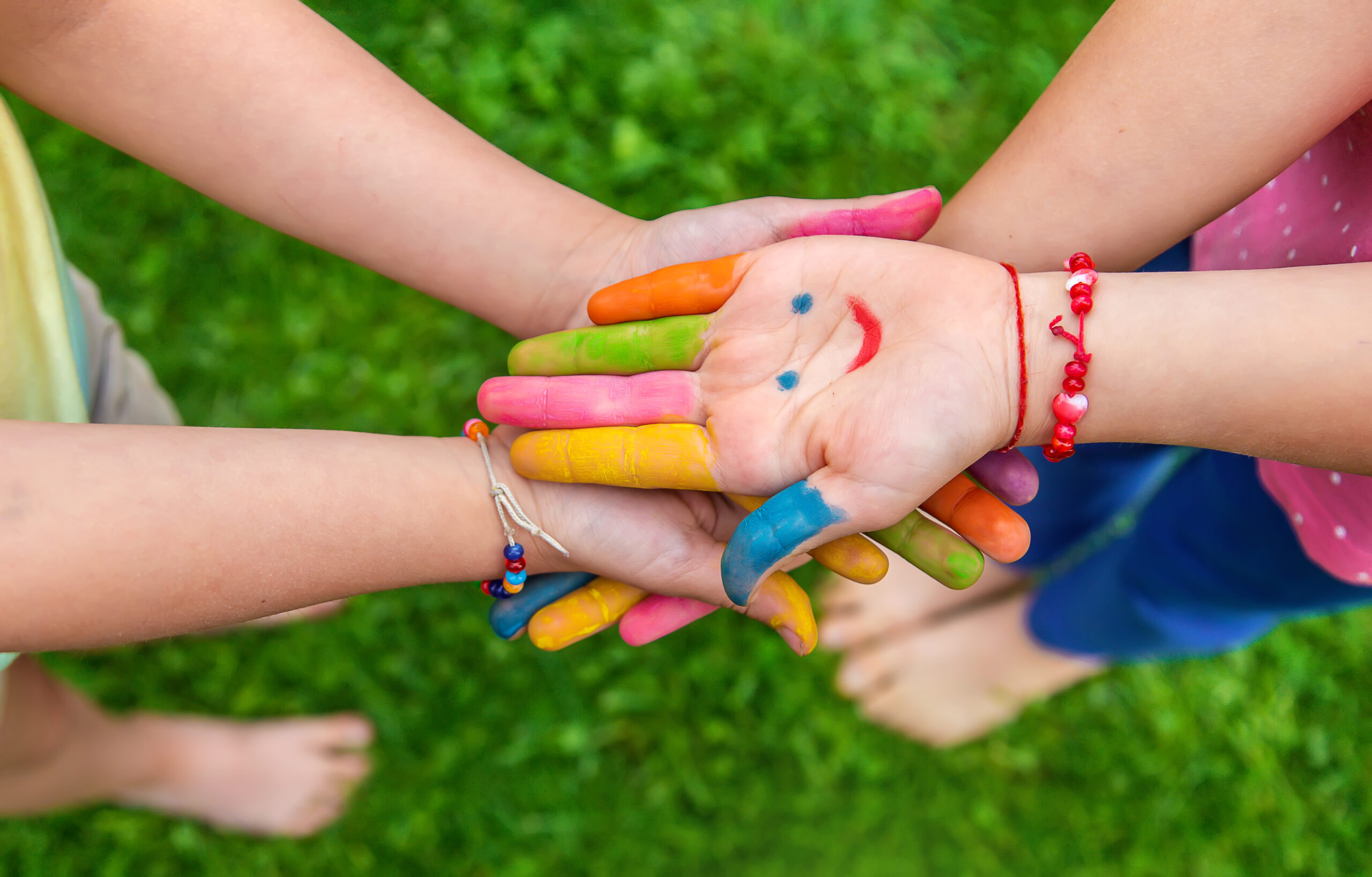 Hands of a child with a drawn emoticon. Selective focus.